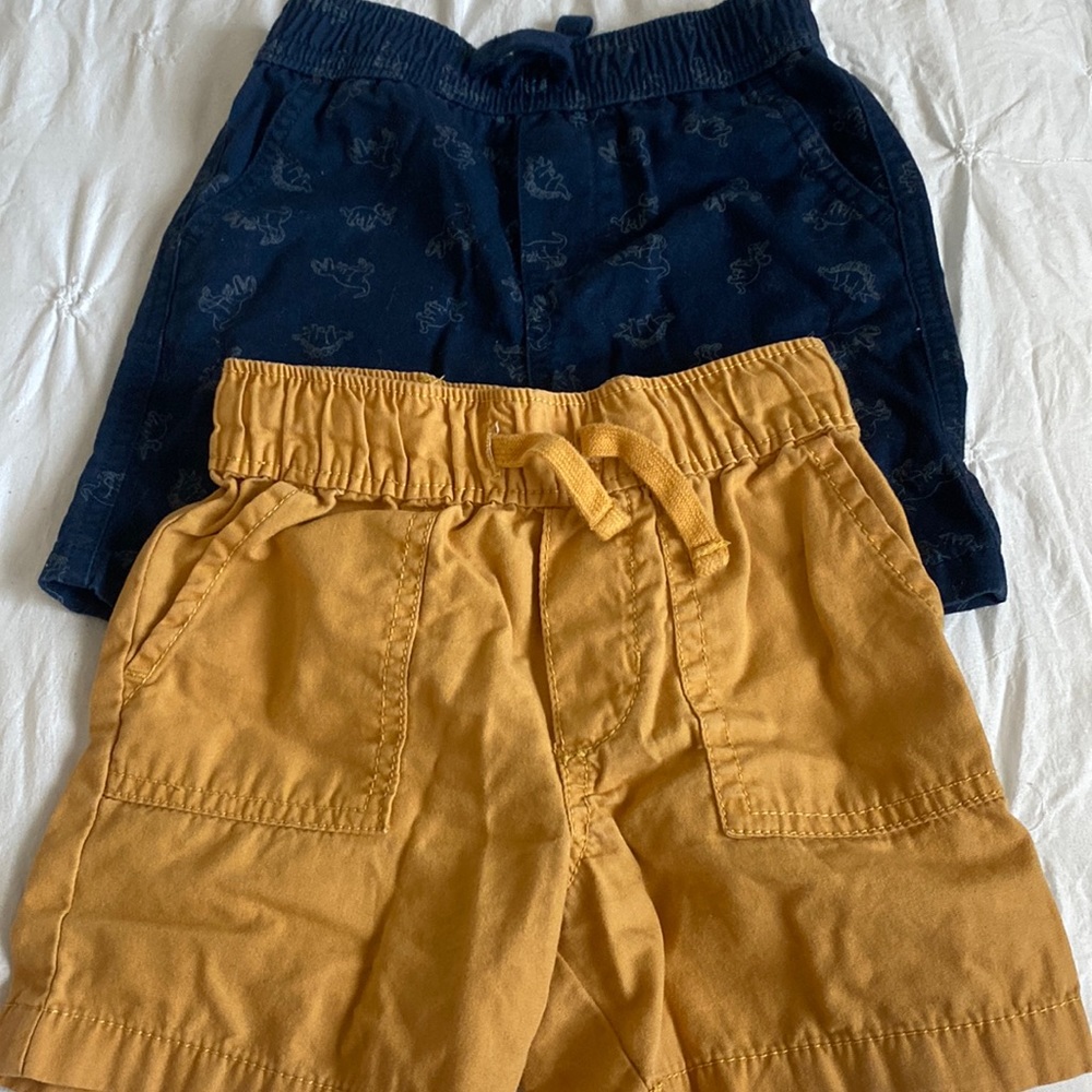 Two infant shorts, blue and gold shorts.